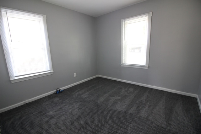 empty room featuring dark carpet