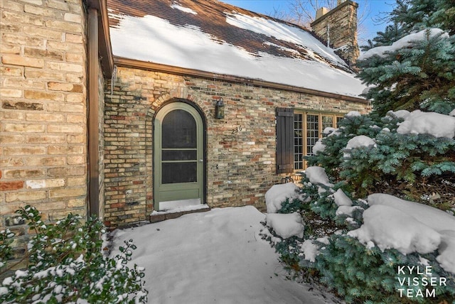 view of snow covered property entrance