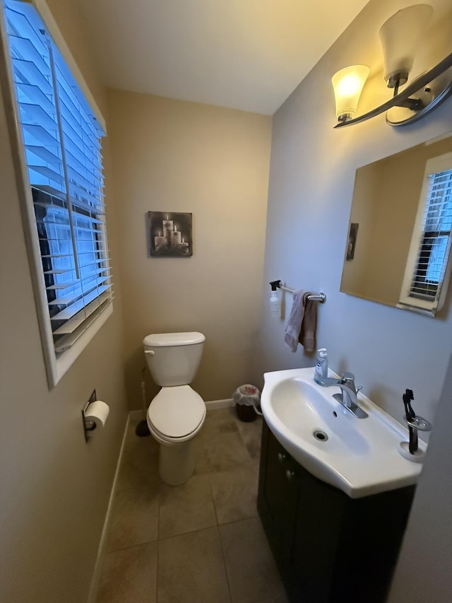 bathroom featuring tile patterned flooring, vanity, and toilet