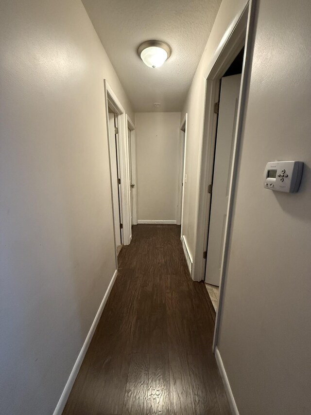 hallway featuring dark hardwood / wood-style floors