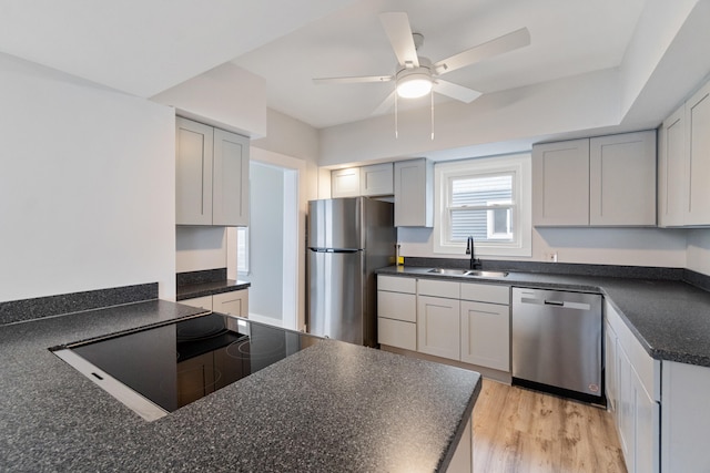 kitchen with ceiling fan, sink, light hardwood / wood-style flooring, gray cabinets, and appliances with stainless steel finishes