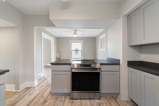 kitchen featuring light hardwood / wood-style flooring, stainless steel electric stove, and gray cabinetry