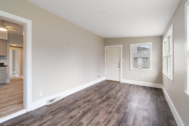 spare room featuring vaulted ceiling, ceiling fan, and dark wood-type flooring