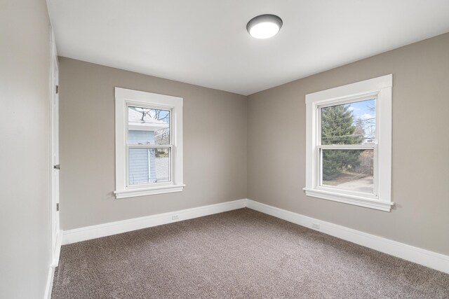 empty room with plenty of natural light and carpet floors