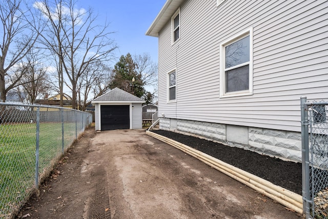 view of home's exterior with a garage and an outdoor structure