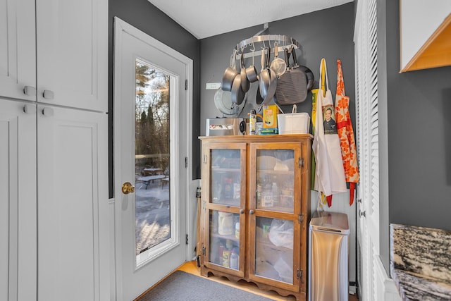 doorway to outside featuring a textured ceiling and an inviting chandelier