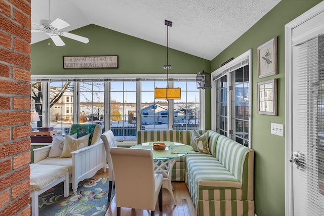 sunroom / solarium with ceiling fan and lofted ceiling