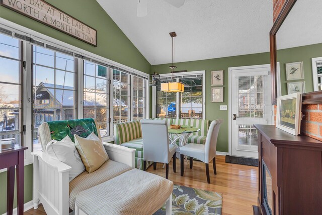 sunroom featuring ceiling fan and vaulted ceiling