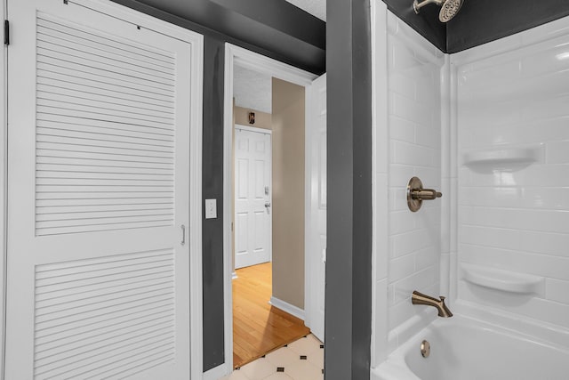 bathroom featuring wood-type flooring and  shower combination