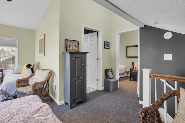 carpeted bedroom featuring a textured ceiling and vaulted ceiling