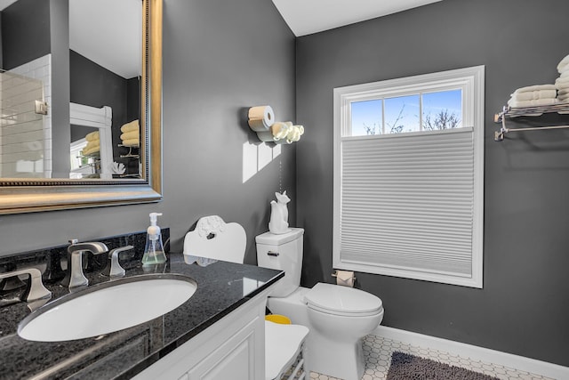 bathroom featuring tile patterned flooring, vanity, and toilet