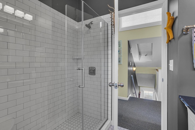 bathroom with a shower with door