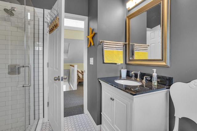 bathroom featuring tile patterned floors, vanity, and a shower with shower door