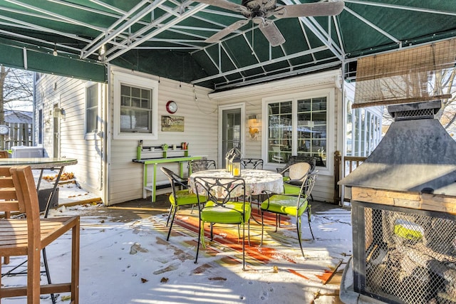 snow covered patio featuring ceiling fan