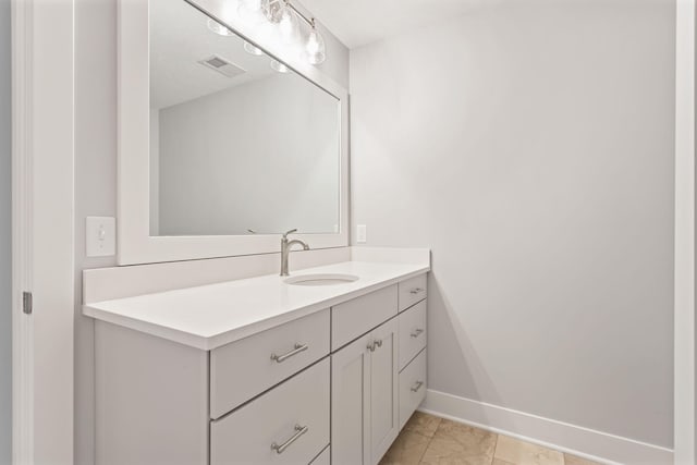 bathroom featuring tile patterned flooring and vanity