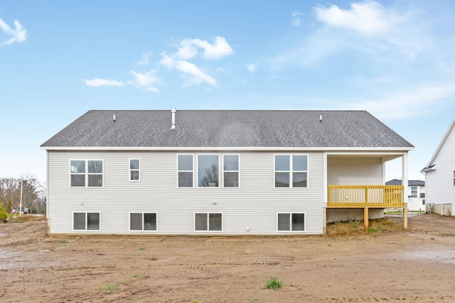 rear view of property featuring a deck