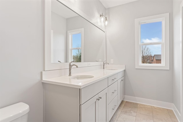 bathroom featuring vanity and toilet