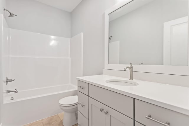 full bathroom with washtub / shower combination, vanity, tile patterned floors, and toilet