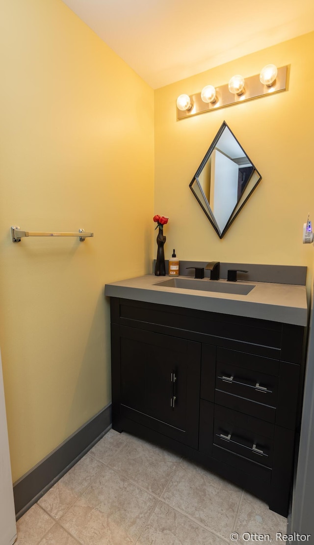 bathroom featuring tile patterned flooring and vanity