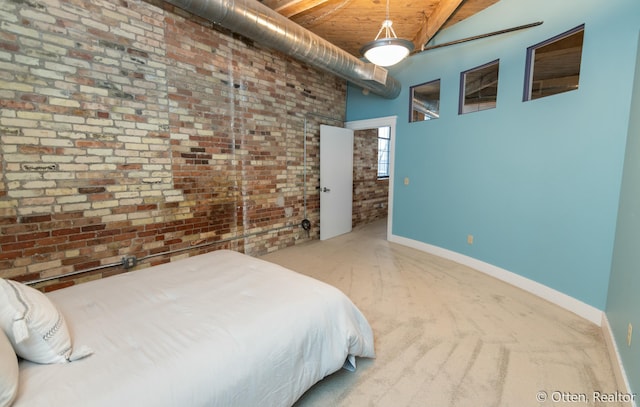 bedroom with carpet floors, high vaulted ceiling, wooden ceiling, and brick wall