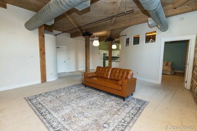 living room with beamed ceiling, carpet floors, and wood ceiling