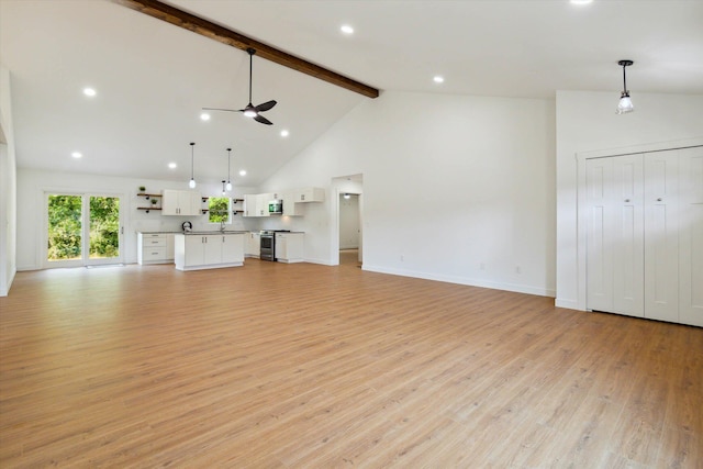 unfurnished living room with beamed ceiling, ceiling fan, high vaulted ceiling, and light hardwood / wood-style flooring