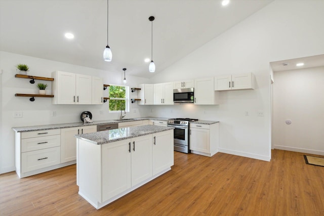 kitchen featuring pendant lighting, stainless steel appliances, and white cabinetry