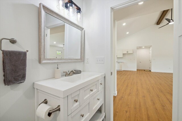 bathroom with lofted ceiling with beams, ceiling fan, wood-type flooring, and vanity