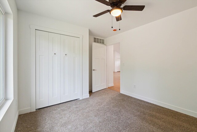 unfurnished bedroom with ceiling fan and carpet floors