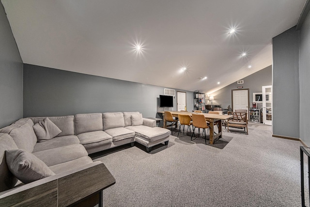 carpeted living room with lofted ceiling