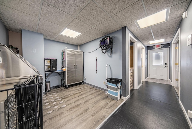 misc room with hardwood / wood-style flooring and a paneled ceiling