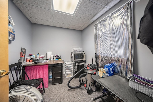 carpeted home office featuring a drop ceiling