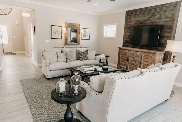 living room with crown molding, ceiling fan, and light hardwood / wood-style floors