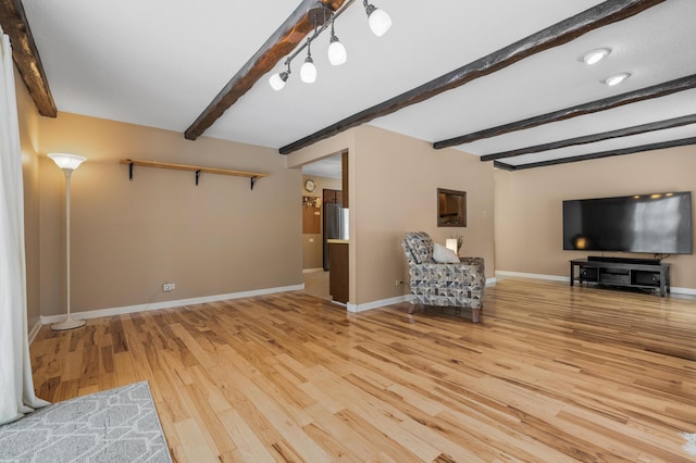 unfurnished room featuring beam ceiling and wood-type flooring