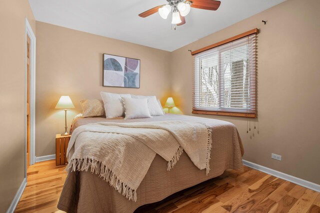 bedroom with light hardwood / wood-style flooring and ceiling fan