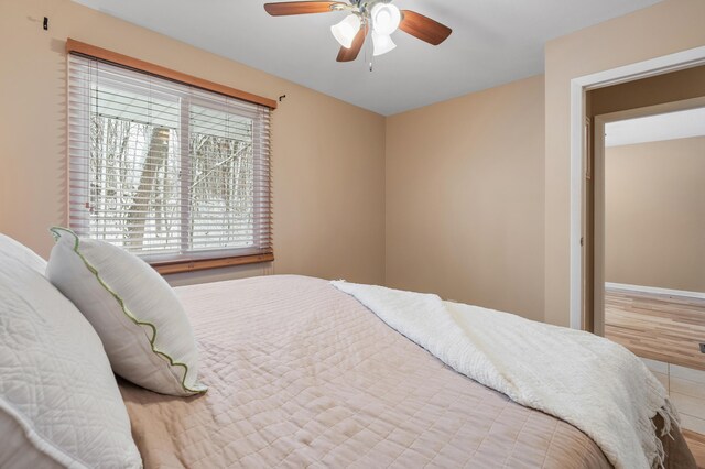 bedroom with ceiling fan and hardwood / wood-style floors