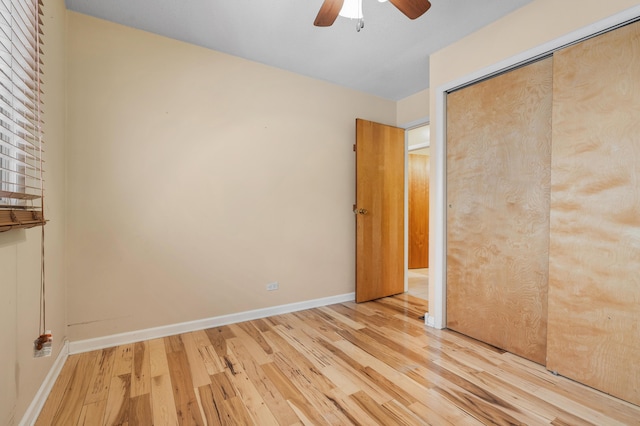 unfurnished bedroom featuring ceiling fan, a closet, and light hardwood / wood-style floors