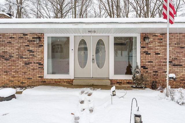 view of snow covered property entrance