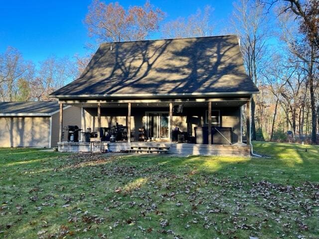 rear view of property with a patio area and a lawn