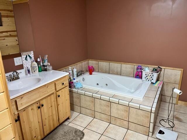 bathroom with tile patterned floors, vanity, and a relaxing tiled tub