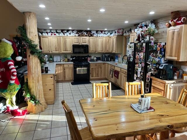 kitchen featuring light brown cabinets, sink, light tile patterned floors, and black appliances