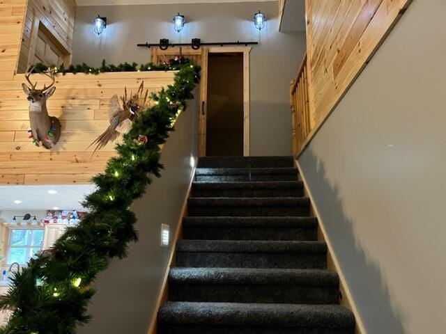 stairs featuring wooden walls