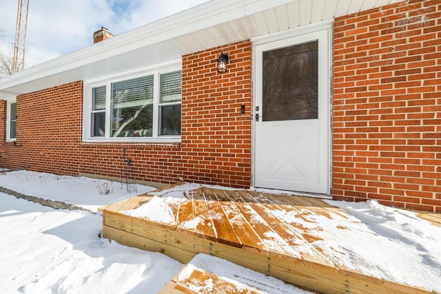 view of snow covered property entrance