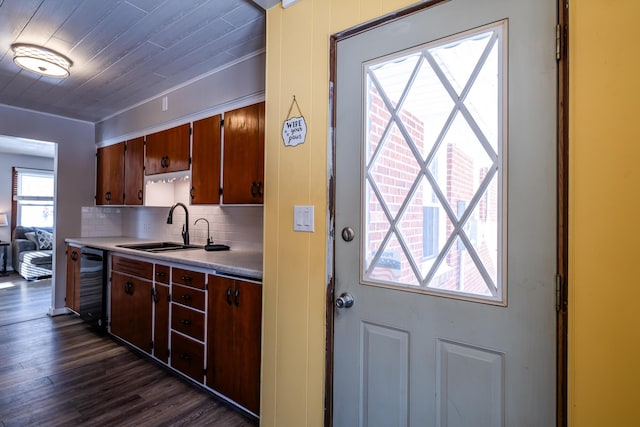 kitchen with sink, black dishwasher, dark hardwood / wood-style floors, backsplash, and ornamental molding