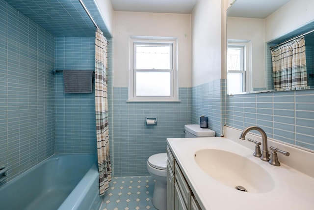 full bathroom featuring shower / bath combo, vanity, toilet, and tile walls