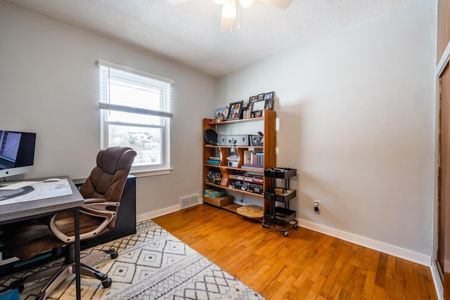 office space with hardwood / wood-style floors, ceiling fan, and a textured ceiling