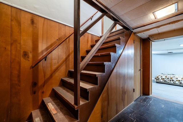 staircase with wood walls