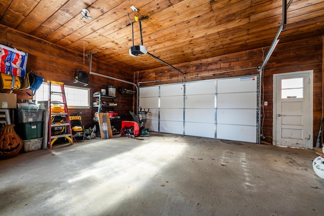 garage with wooden walls, wooden ceiling, and a garage door opener