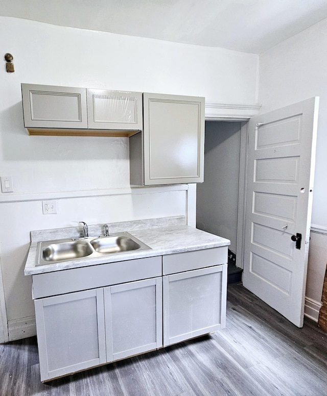 kitchen featuring gray cabinetry, sink, and dark hardwood / wood-style flooring