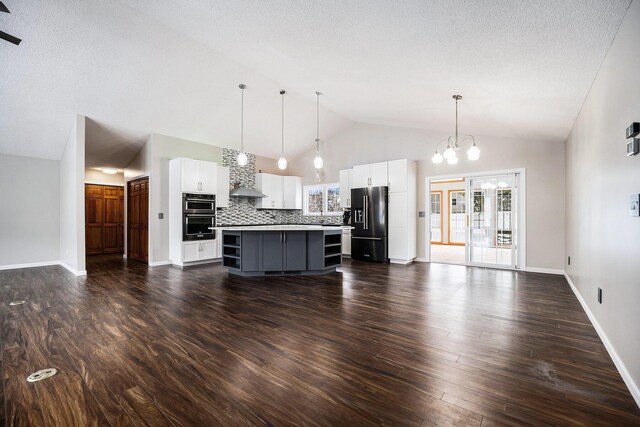 kitchen featuring stainless steel appliances, dark wood-type flooring, white cabinetry, a kitchen island, and hanging light fixtures